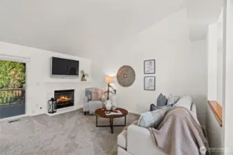 Living room with fireplace and access to rear deck.