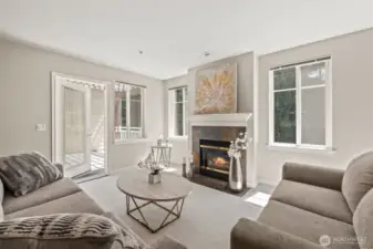 Large living room space leads to outdoor  deck. Lots of windows & gas fire place add to brightness & warmth .