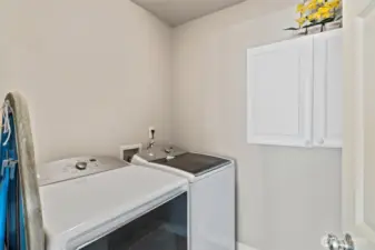 Designated laundry room off the kitchen.