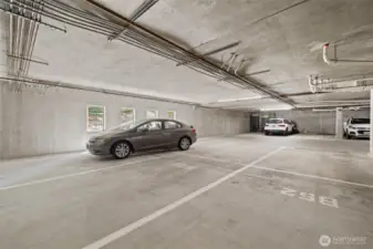 Middle parking tandem spots  is room enough for 2 large cars. This garage is well lite and spacious.