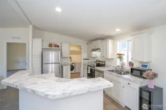 The kitchen boasts a new stainless steel stove/oven, with a conveniently located utility room just steps away.