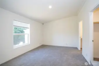 Bright and inviting primary suite, enhanced with fresh new carpeting.