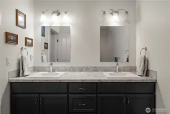 Through the walk-in closet, an ensuite bathroom provides everything you need for discrete living downstairs.