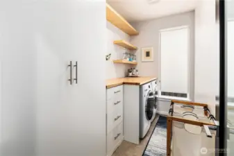 Built ins, shelves, and butcher block counter added to the laundry room