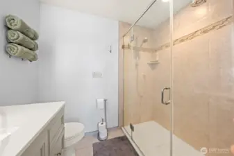 The 3/4 bathroom in the primary bedroom has a large walk-in shower