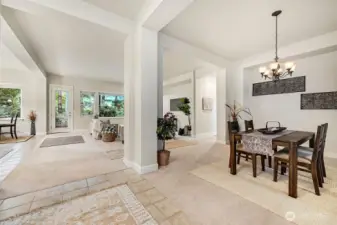 Upon entry, an open and airy living room awaits, with the dining room gracefully set to the right for seamless entertaining.