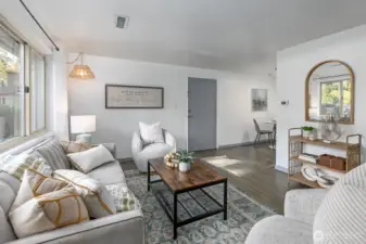 Living area with large picture window, each bedroom has ample closet space and natural light.