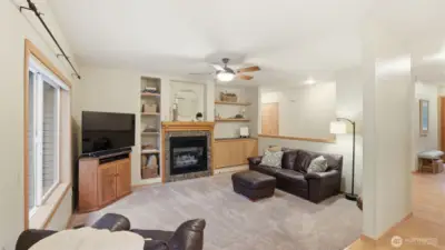 Cozy sunken family room with gas fireplace & built-ins