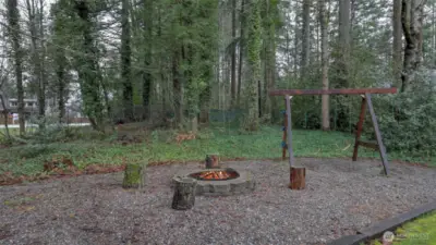 Park-like grounds with fire pit and swingset