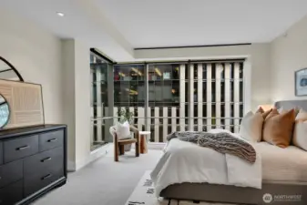 Retreat to the primary bedroom where automated shades can provide two levels of privacy.