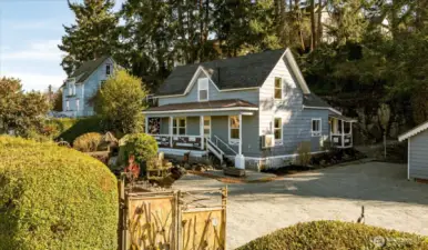 Inside the gated entry, a spacious courtyard and detached shop create flexibility for hobbies, studio space, or projects.