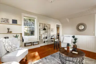 Natural light fills the room and settles over a charming window seat, a perfect place for reading or quiet contemplation.