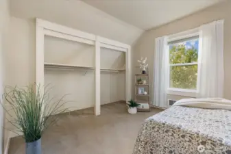 Generous closet space provides practical storage while maintaining the clean, open feel of the bedroom.