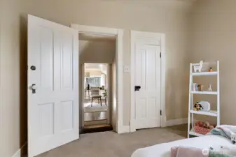 Classic doors and warm neutral tones create a charming upstairs landing that connects the bedrooms and loft space.