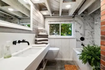 Enjoy getting ready in this spa-like downstairs bath with brick accent wall.