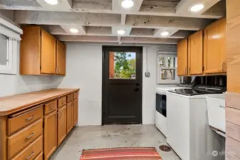 Downstairs utility area with access to the backyard.