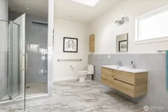 The primary bath with a gorgeous custom shower and ample space to get ready.