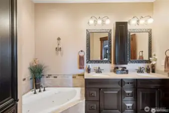 Primary bathroom with double sinks/vanities and a jetted tub.