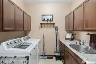 Utility room with sink and lots of storage. Washer & dryer are included with the sale.