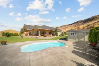 Pool and pumphouse, looking back towards the home and yard.
