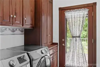 Utility with newer front load washer and dryer and Covered deck access off of the kitchen
