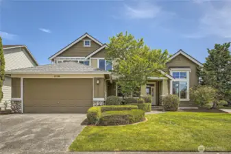 Beautiful two-story home located at 270 Kitsap Ave NE, Renton. The property boasts great curb appeal with its well-manicured landscaping, lush green lawn, and neatly trimmed hedges. The exterior features a harmonious blend of earthy tones, stone accents, and craftsman-style architectural details. A large 3-car tandem garage anchors the left side of the home, while a charming covered entryway framed by columns and greenery welcomes you inside. Tall windows bring in an abundance of natural light, and a mature tree adds a touch of privacy and character to the front yard. Set against a clear blue sky, this home offers a warm and inviting first impression.