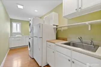 Such a great space! Laundry folding space, utility sink, extra fridge and more storage!