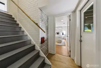 The stairs lead to the fully finished lower level. The door on the right goes straight out to the garden yard.