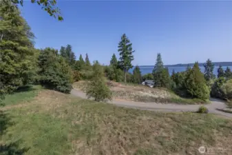 This 2.45 acre parcel is on a private, dead-end road with few homes. This elevated lot has about a 100 foot wide cleared area that would make an ideal building site. Power, cable are in the street, Bridgehaven water hook-up is available for $9,700 fee, and there's a connection for the community drain field for Lot 2.