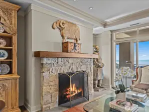 Gas fireplace with stone surround.