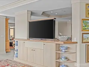 Family room TV that ascends from the cabinet below.