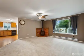 Spacious living room with free standing wood stove, new plush carpets, overlooking the back yard