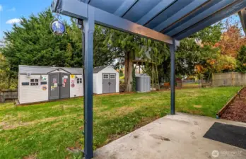 Covered patio looking toward 3 high quality shed/ workshops