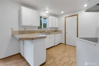 Convenient kitchen with eating bar, all appliances, pantry and bright window which looks out to your private backyard.  Abundant kitchen storage.