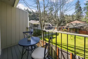 Deck overlooking lawn and greenbelt.