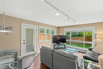 Living Room has lots of windows with green views of trees and yard