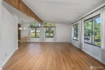 As you enter, the large living room w/ vaulted ceilings welcomes you in. Notice the huge windows to keep it bright thru out the seasons.