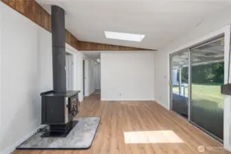 Wood-burning stove keeps the whole house warm! Slider opens to a large covered deck.