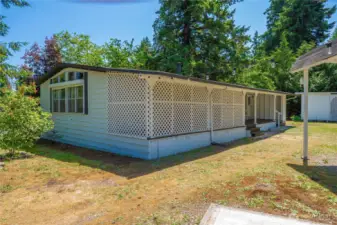 Looking at the back of the home toward the enclosed privacy space and covered back deck.