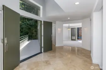 Standing in the entry looking out to the bridgeway and straight into the family room.