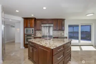 The slider walks out to the side deck. The island design is great for entertaining or everyday.