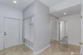 The lower level landing with the garage to the left and bedrooms to the right. Note the tall ceilings.