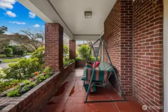 The private, covered front porch off of the living room is the perfect location to relax and take in the neighborhood, rain or shine