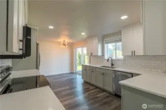 Updated kitchen with granite counter tops, tile backsplash, SS appliances. New flooring throughout the entire home. Home has been nicely updated. Area off kitchen for informal eating. There is also a formal dining area.