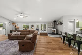 An expansive great room offers a comfortable space to share with your loved ones.  The vaulted ceiling and luxury vinyl plank flooring is both durable and beautiful creating an open airy space.