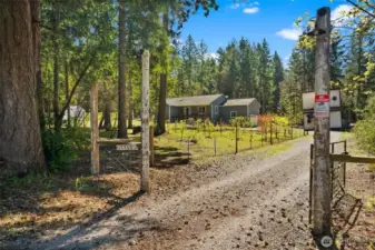 The gated entry leads to a long driveway where you pass an enclosed orchard on the left.  Featuring over 25 fruit trees and a variety of berry plants, you will have everything you need to bake organic country pies!