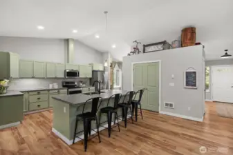 The soft green paint in the kitchen adds the perfect pop of color to this well-loved and highly functional space.