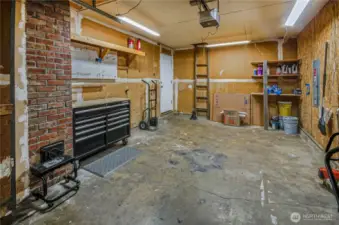 The garage has an electric opener, and there is ample workshop space as well.