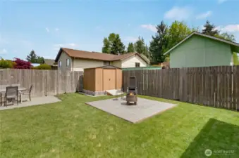 The third of three patio seating areas is perfect for a firepit! Here you also see the ramp accessing the garden outbuilding, which makes mower access easy.