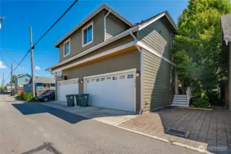 Alley perspective with garage, additional parking, and ADU access from side stairs